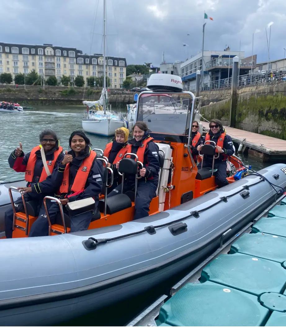 Group of friends celebrating a hen or stag party with a lively boat tour experience