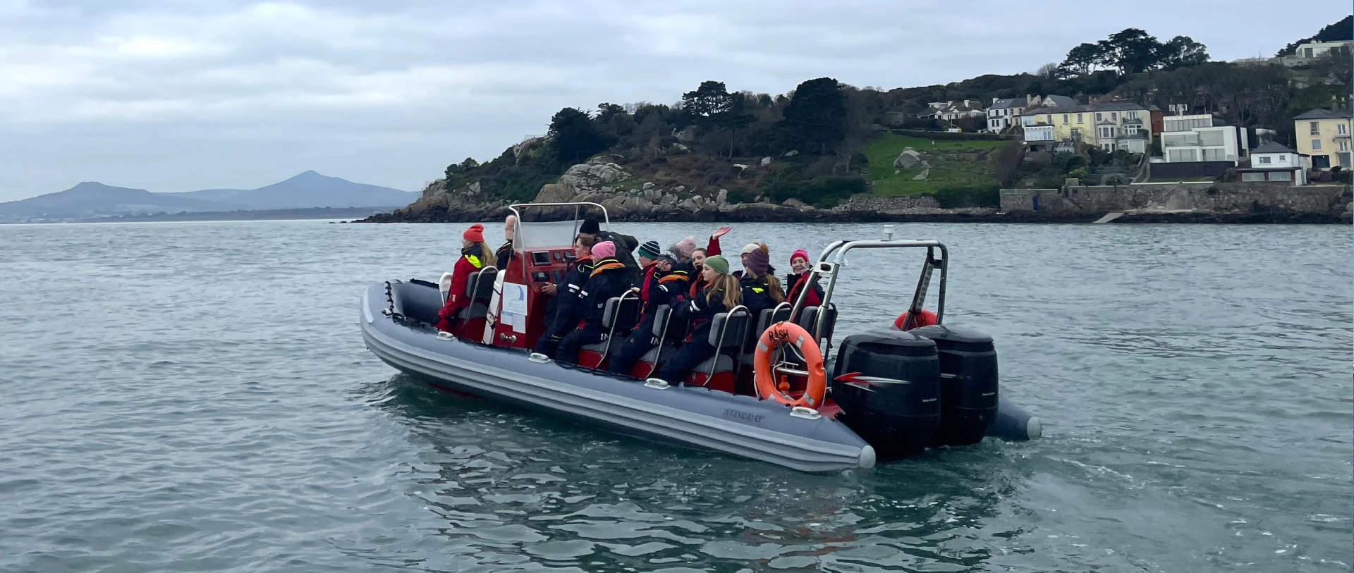 School group of students and teachers enjoying an educational boat tour with scenic views